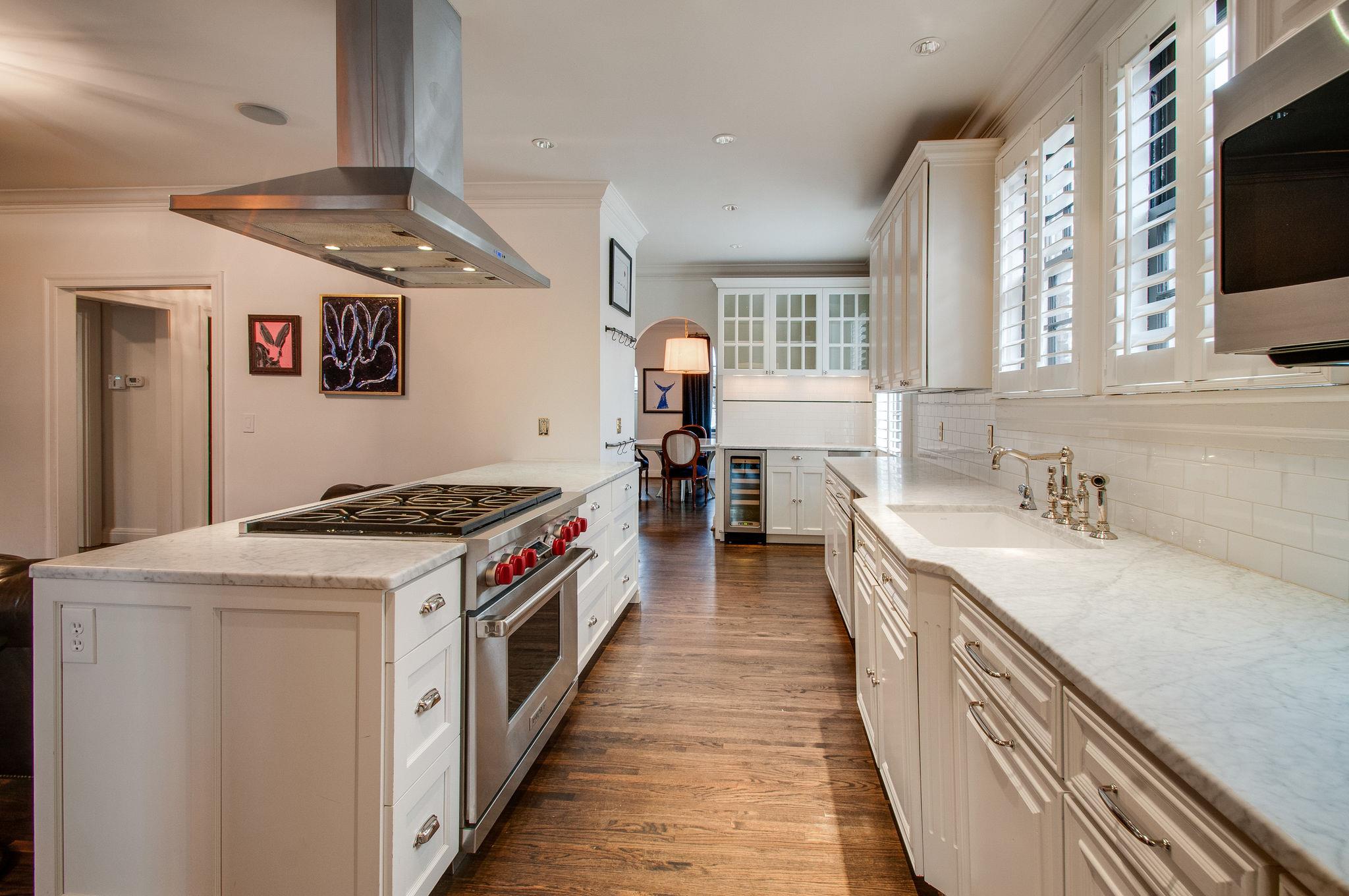 232 Cherokee Road Nashville, TN 37205 - Photo 8 of 24 a kitchen with stainless steel appliances granite countertop a stove and a sink