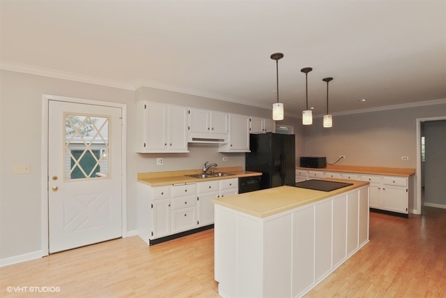 5 Oakwood Road Indian Creek, IL 60061 - Photo 3 of 18 a kitchen that has a lot of cabinets in it and wooden floor