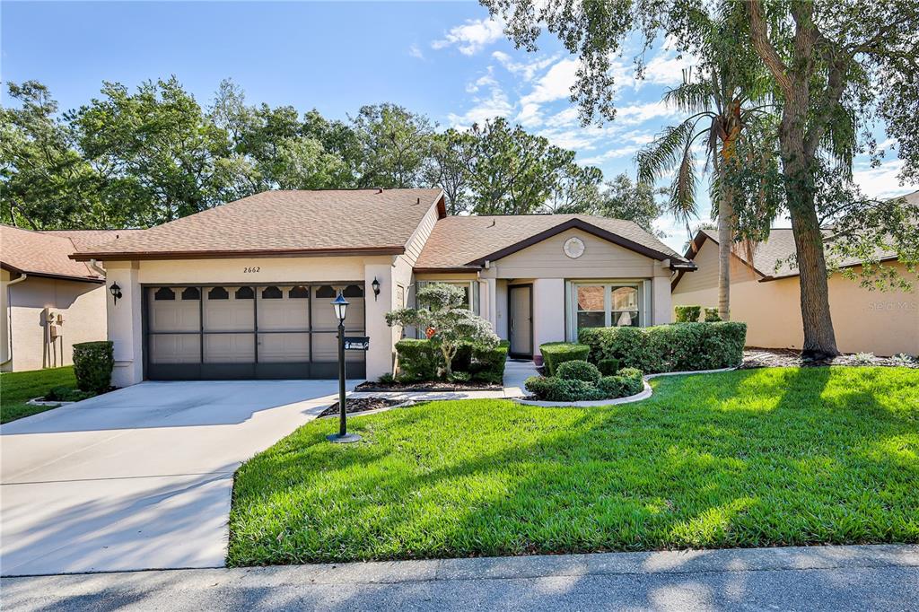 2662 Appleleaf Court Spring Hill, FL 34606 - Photo 34 of 47 a front view of a house with a yard and garage