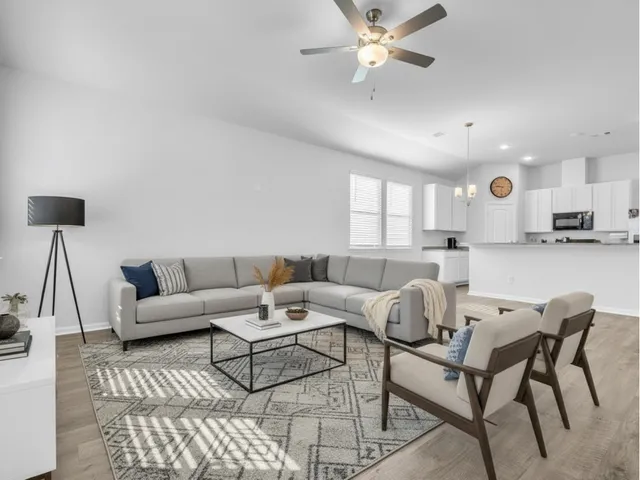 a living room with furniture and a large window