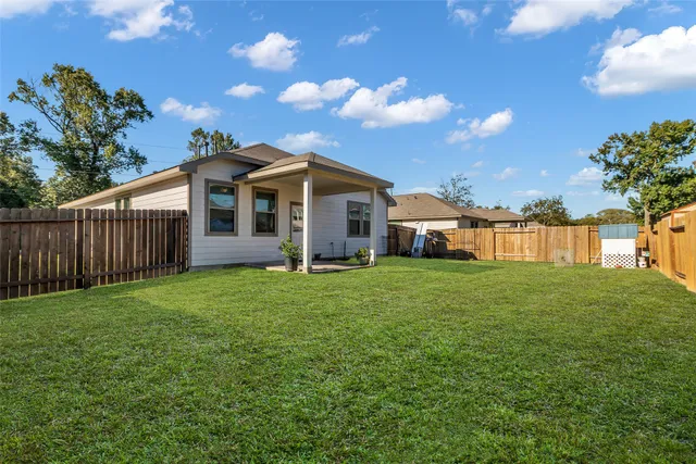 a view of a house with yard and a garden
