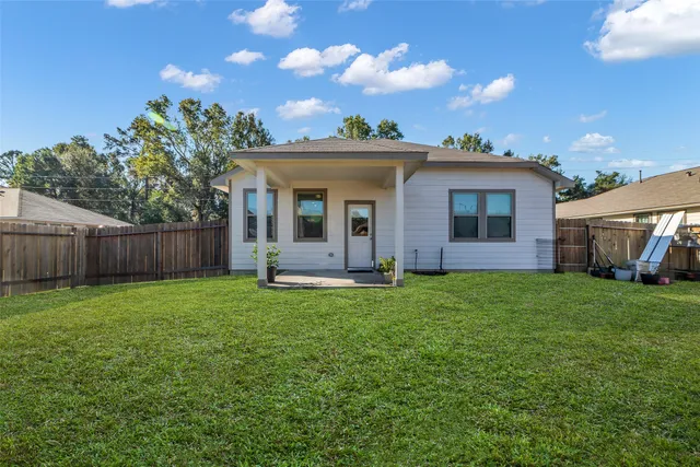 a view of a backyard with table and chairs and floor to ceiling window