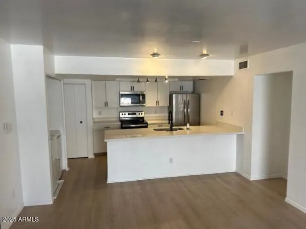 a view of kitchen with wooden floor