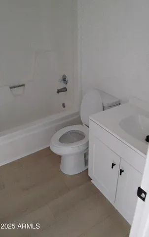 a bathroom with a sink a toilet and bathtub