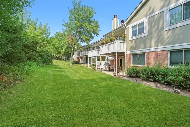 a view of an apartment with a backyard