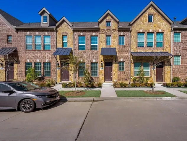a view of a car parked in front of a brick house