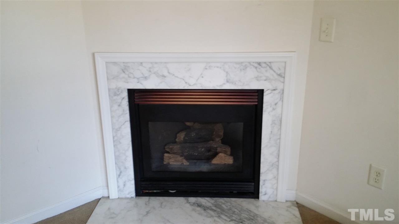 4917 Windsprint Way Raleigh, NC 27616 - Photo 5 of 13 a an empty room with a fireplace