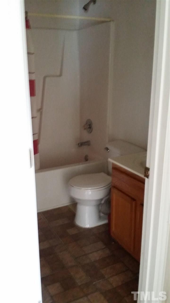 4917 Windsprint Way Raleigh, NC 27616 - Photo 8 of 13 a white toilet sitting next to a shower