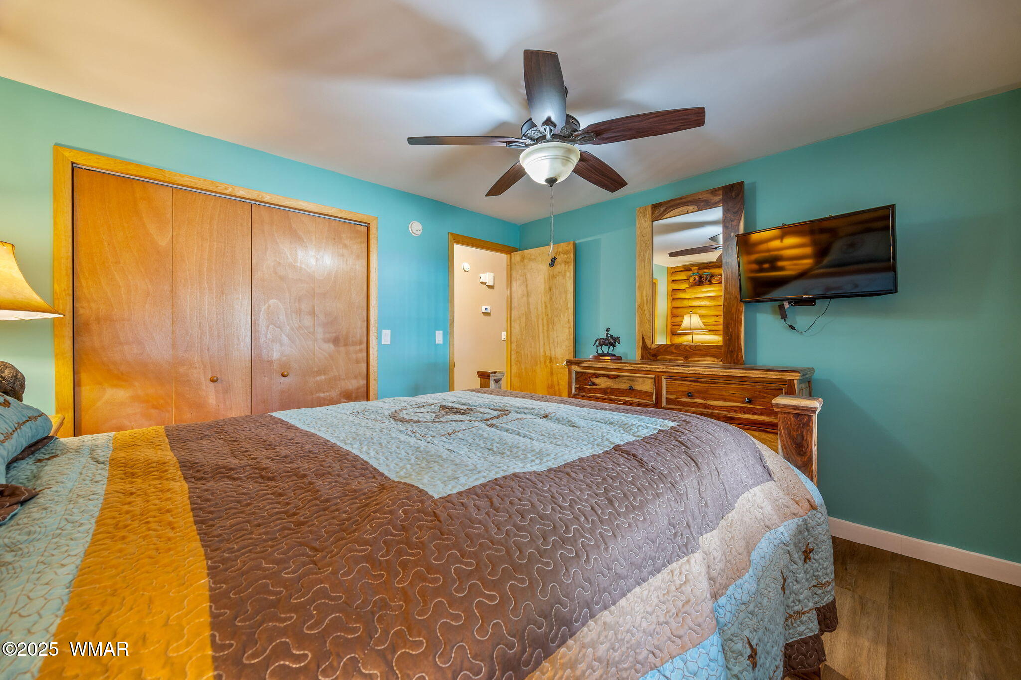 1850 Ansell Road Heber, AZ 85928 - Photo 15 of 34 a bedroom with a bed and a chandelier