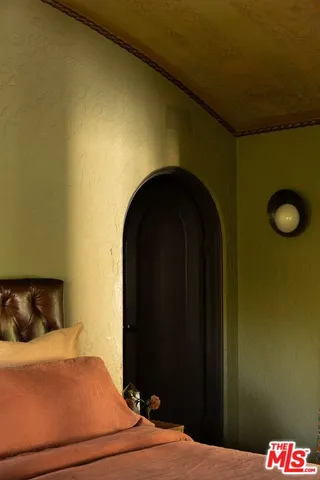 a bedroom with a bed and a table