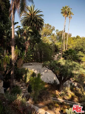a view of swimming pool with a yard and plants
