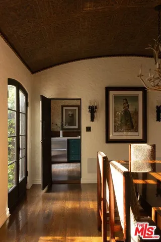 a view of kitchen with furniture and refrigerator