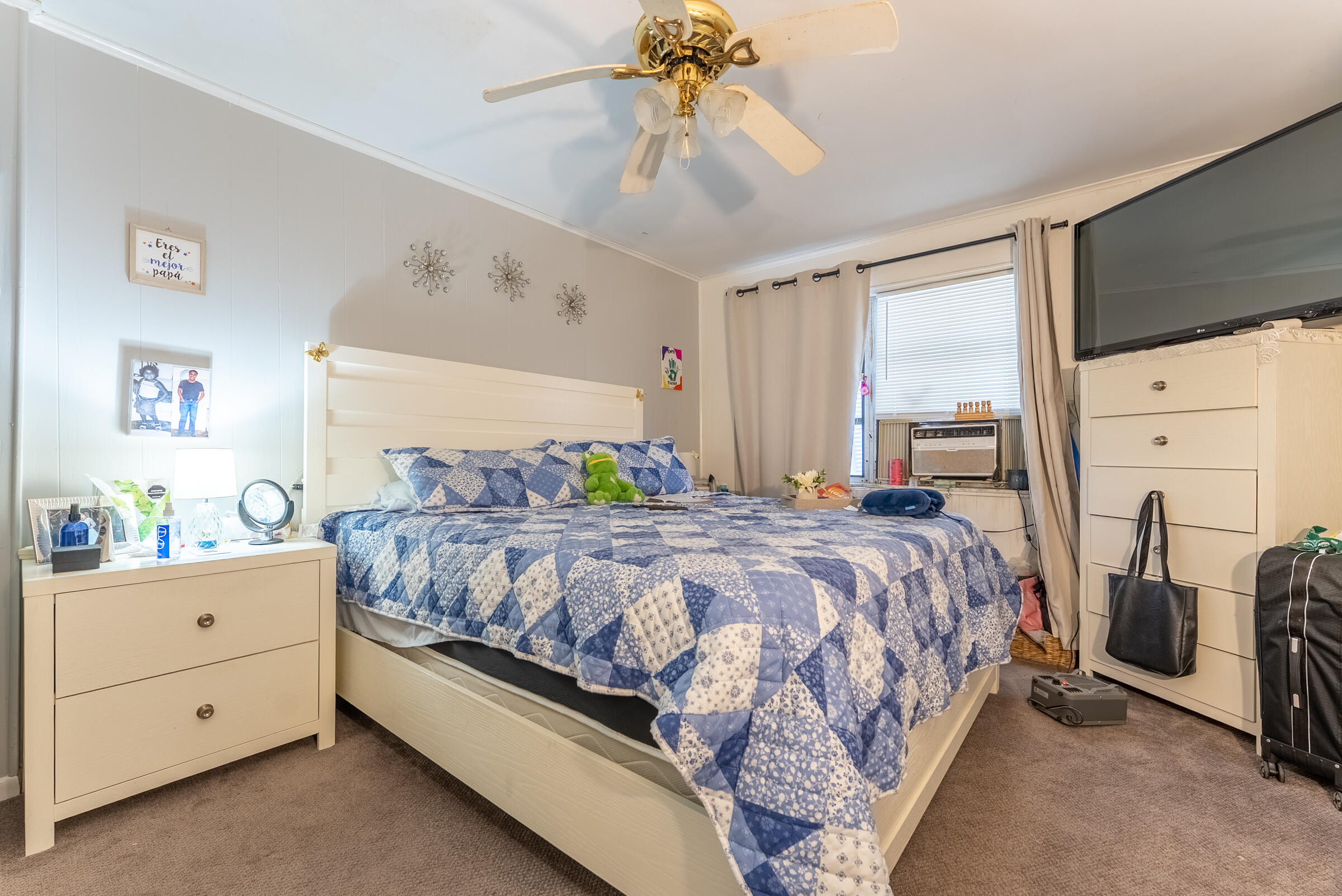 730 North 5th Street Lantana, FL 33462 - Photo 27 of 39 a bedroom with a bed and a chandelier