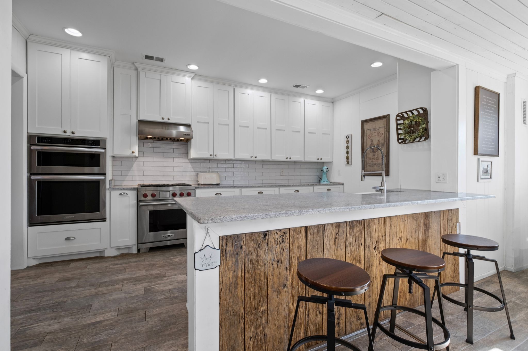 4125 Trinity Road Franklin, TN 37067 - Photo 28 of 44 a kitchen with kitchen island granite countertop a table chairs microwave and cabinets