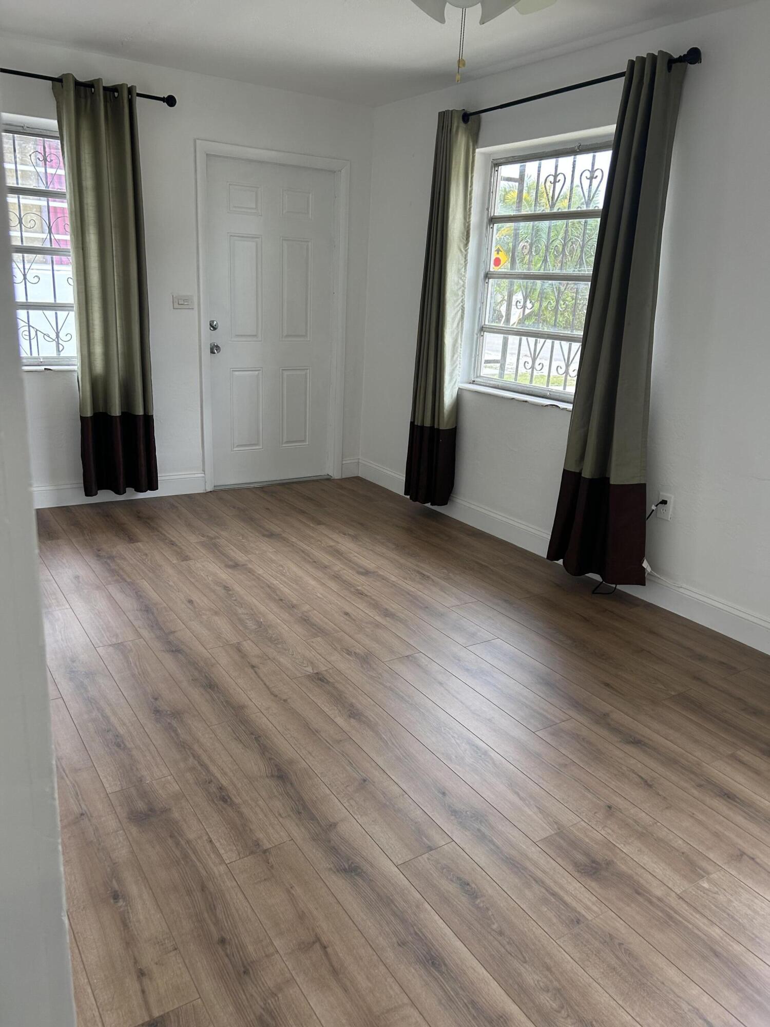 11201 Northeast 3rd Avenue Miami, FL 33161 - Photo 14 of 15 an empty room with wooden floor and windows