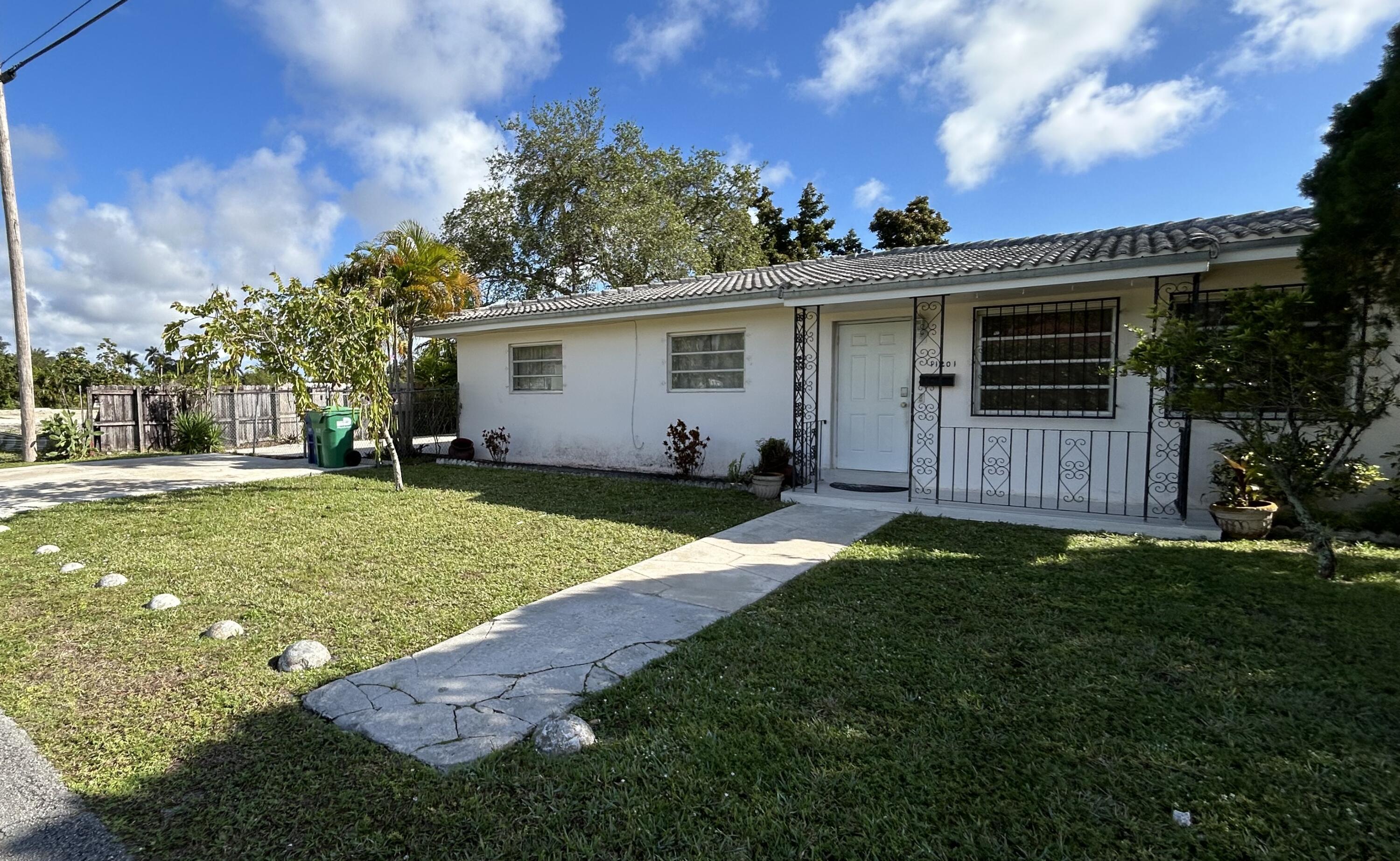 11201 Northeast 3rd Avenue Miami, FL 33161 - Photo 2 of 15 a view of a backyard with a garden
