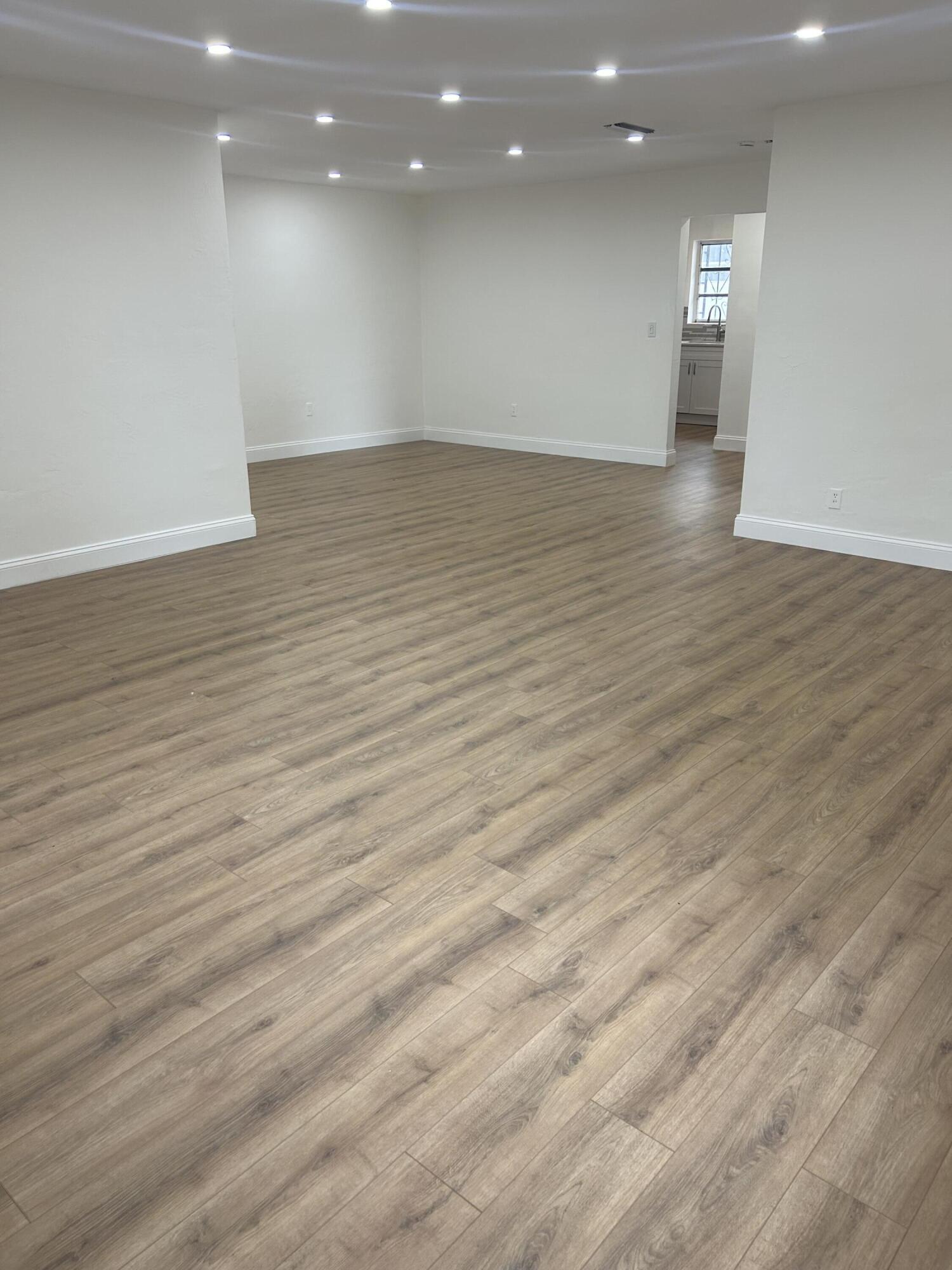 11201 Northeast 3rd Avenue Miami, FL 33161 - Photo 7 of 15 a view of empty room with wooden floor