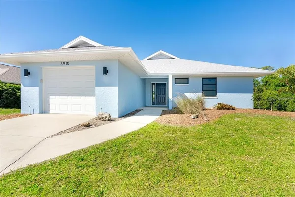 a front view of a house with yard and outdoor seating