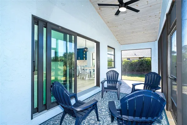 a living room with furniture and a floor to ceiling window