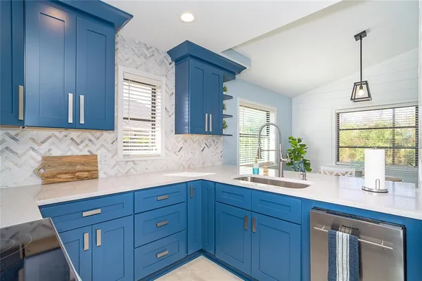 a spacious bathroom with a granite countertop sink mirror and window