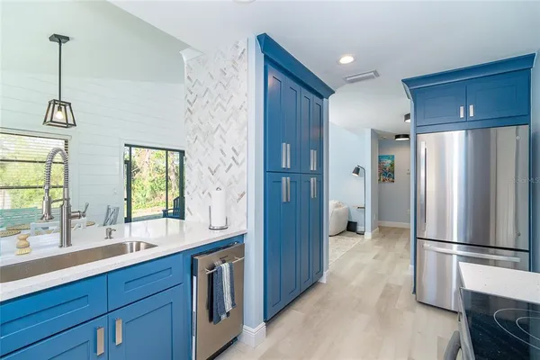 a kitchen with stainless steel appliances a refrigerator and a sink
