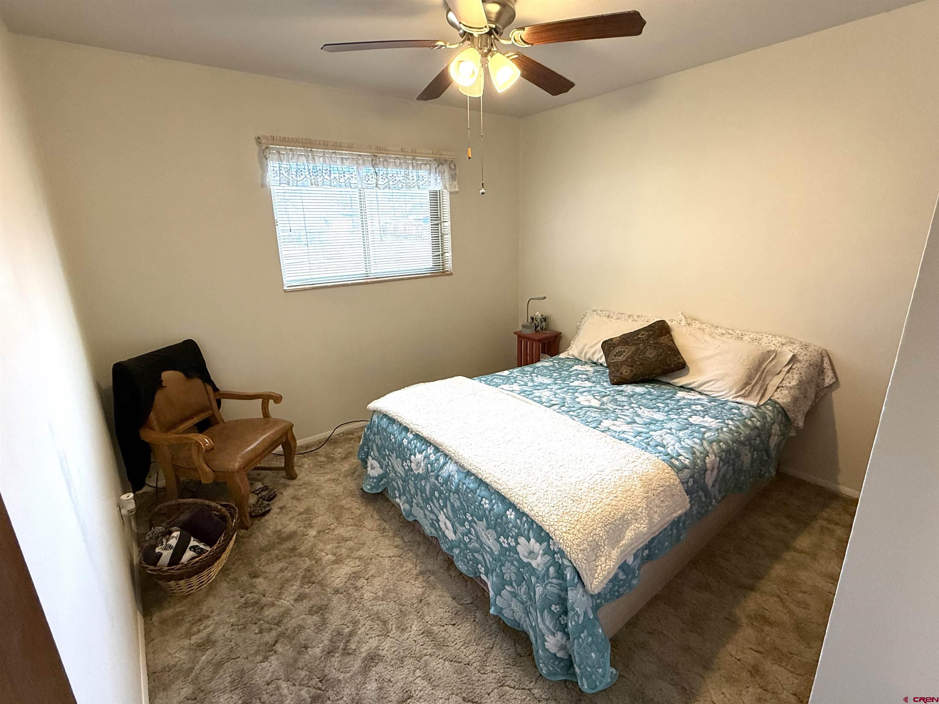 801 East 3rd Street Cortez, CO 81321 - Photo 18 of 22 a bedroom with a bed and a window