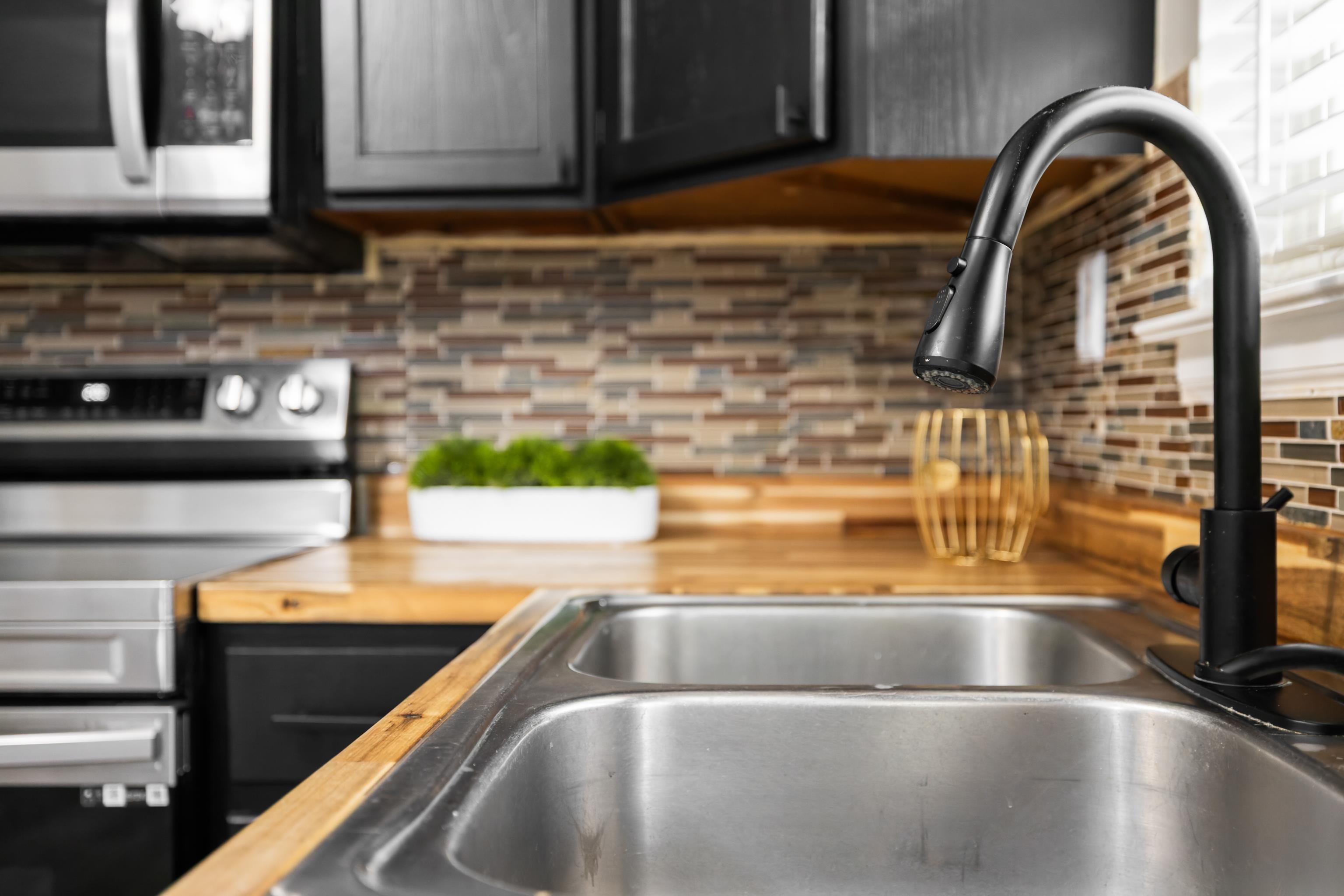 77 Greenway Road Stuarts Draft, VA 24477 - Photo 17 of 57 a kitchen with a sink a counter top space and cabinets