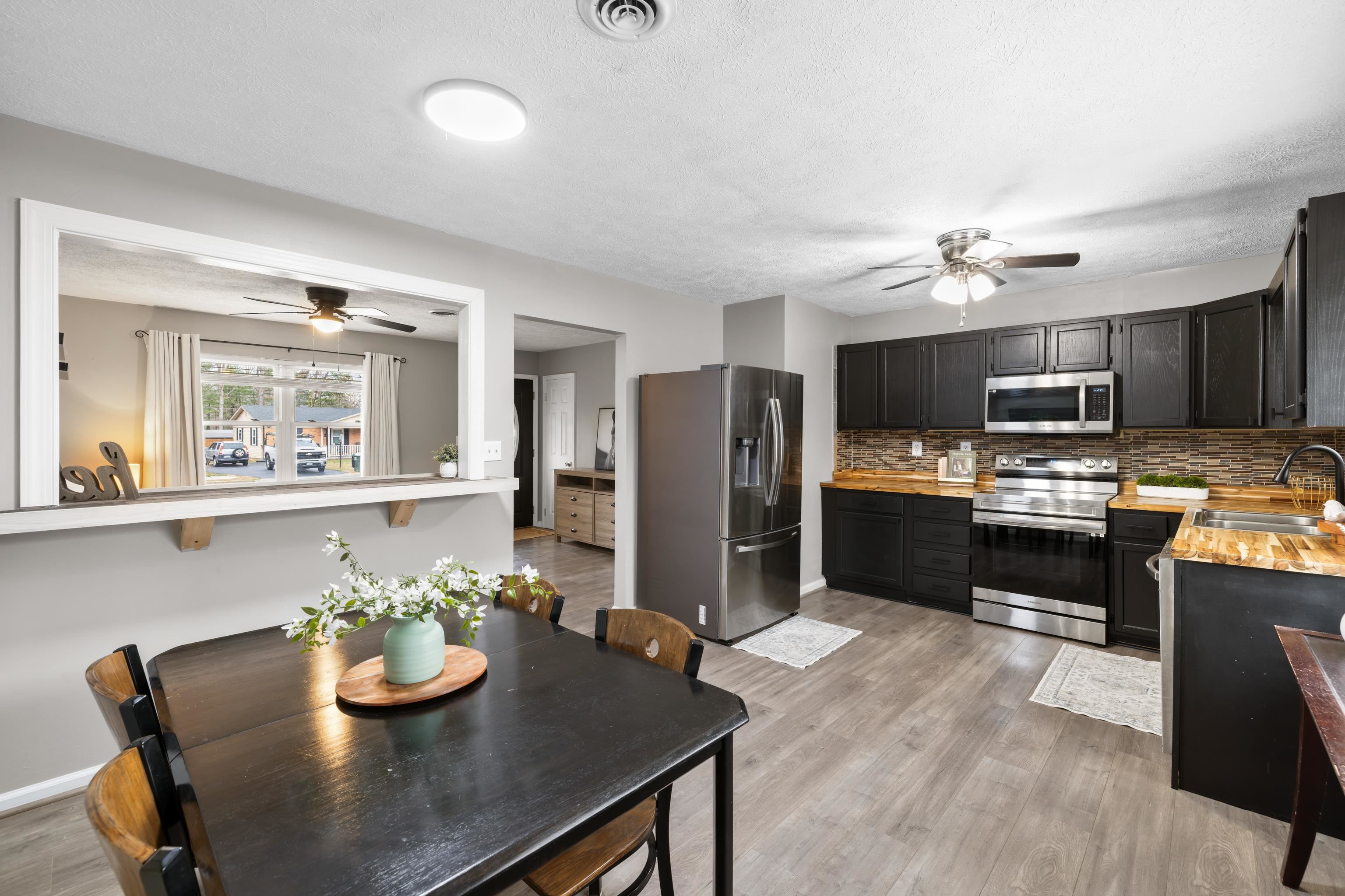 77 Greenway Road Stuarts Draft, VA 24477 - Photo 22 of 57 a kitchen with refrigerator and microwave