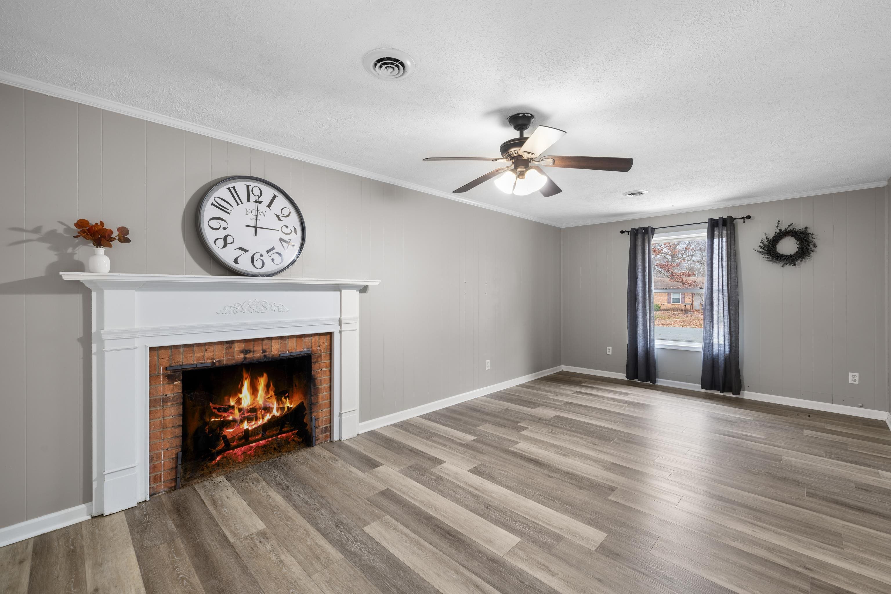 77 Greenway Road Stuarts Draft, VA 24477 - Photo 25 of 57 a view of an empty room with wooden floor a fireplace and a window