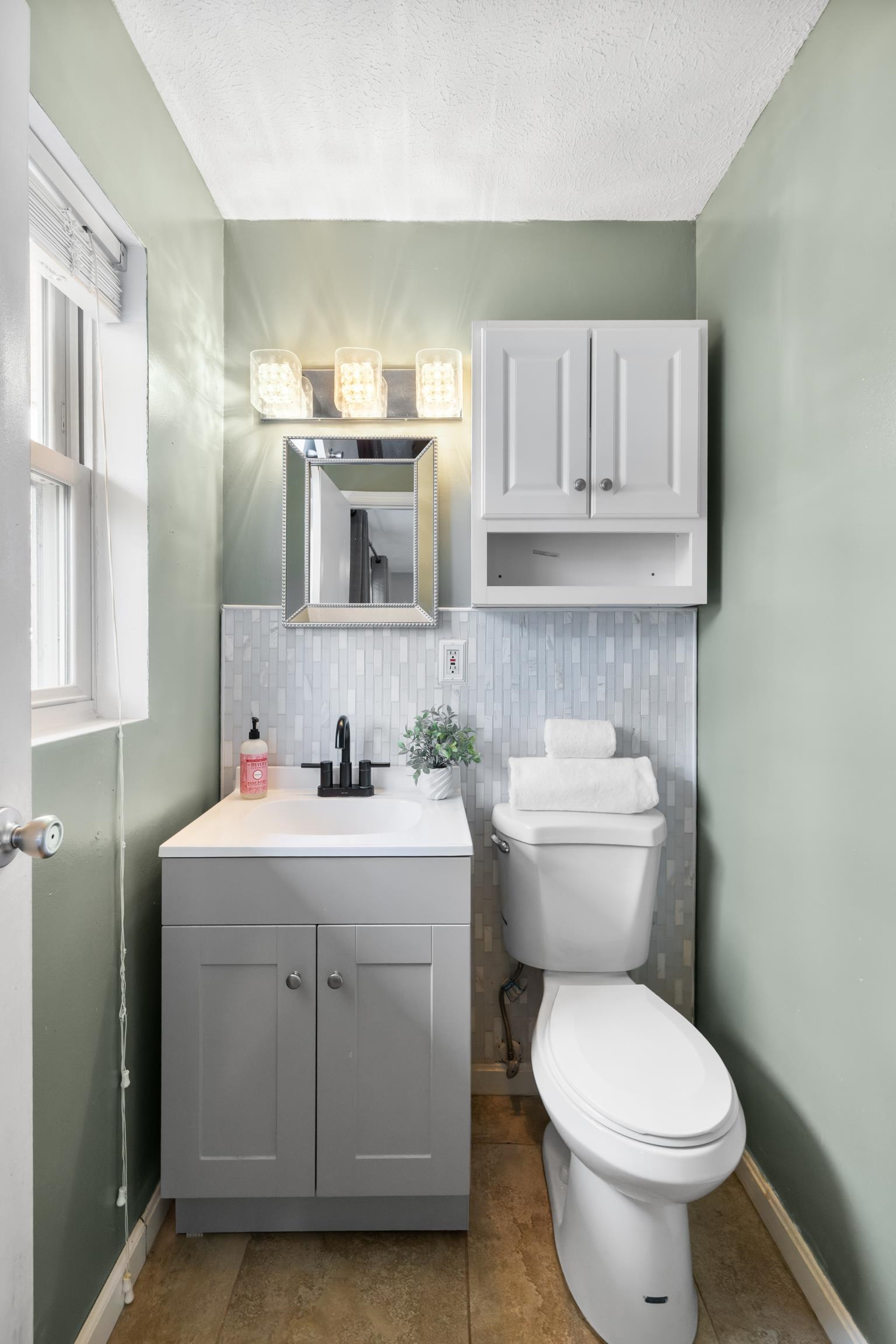 77 Greenway Road Stuarts Draft, VA 24477 - Photo 30 of 57 a bathroom with a sink a toilet and mirror