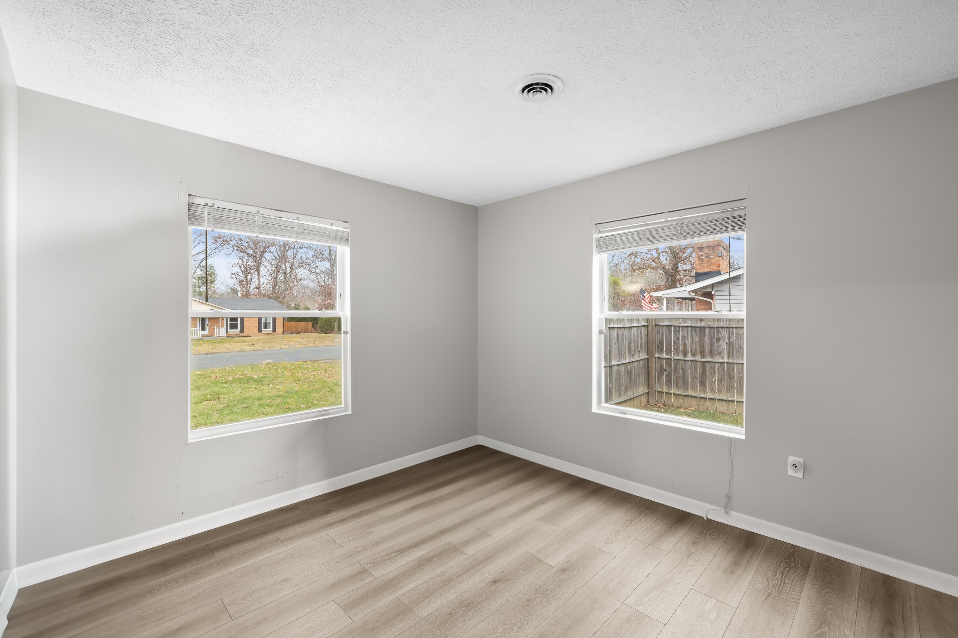 77 Greenway Road Stuarts Draft, VA 24477 - Photo 33 of 57 an empty room with wooden floor and windows