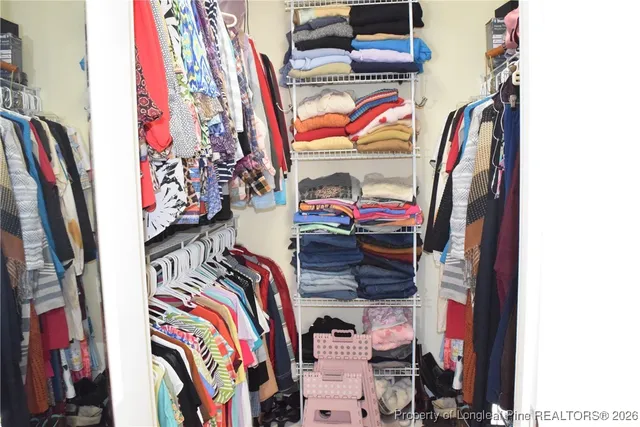 a bedroom with a bed and a dresser in it