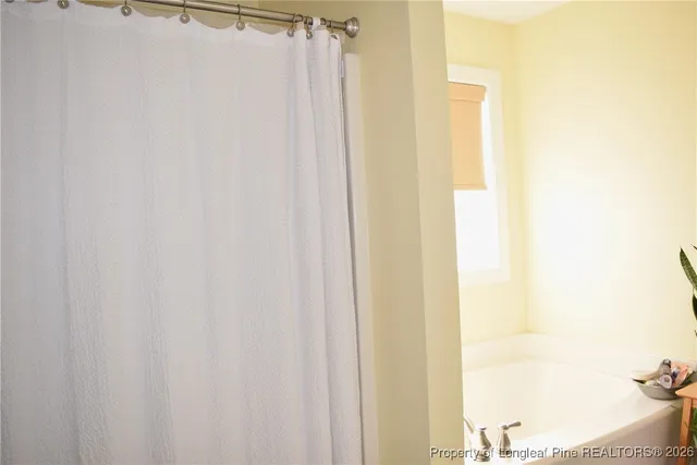 a white toilet sitting next to a shower curtain