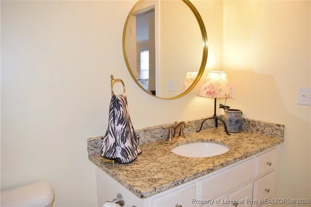 a view of a house with a small yard and wooden floor and fence