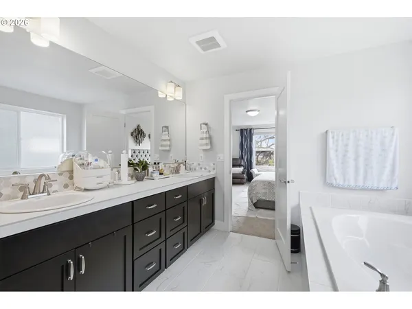 a bathroom with a bathtub and a sink