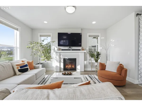 a living room with furniture a fireplace and a flat screen tv