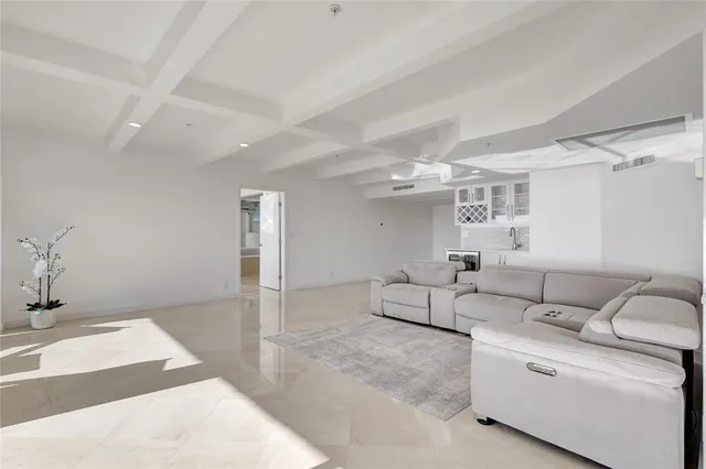 a dining room with wooden floor a chandelier a glass table and chairs