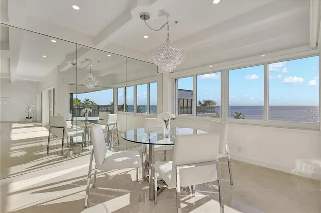 a living room with furniture and large windows