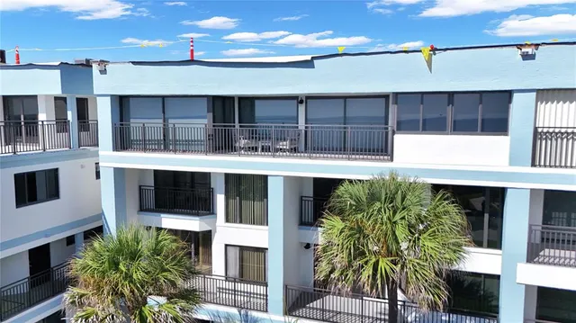 a view of balcony with wooden floor and seating space