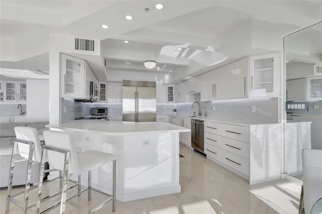 a large kitchen with stainless steel appliances kitchen island granite countertop a large counter top cabinets and stainless steel appliances