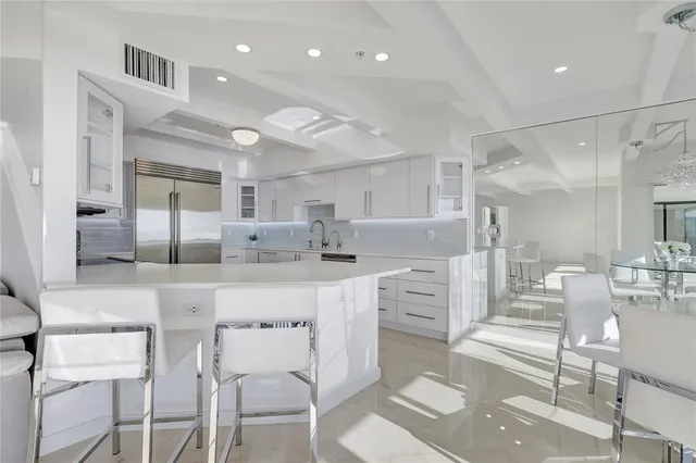 a kitchen with cabinets stainless steel appliances and window