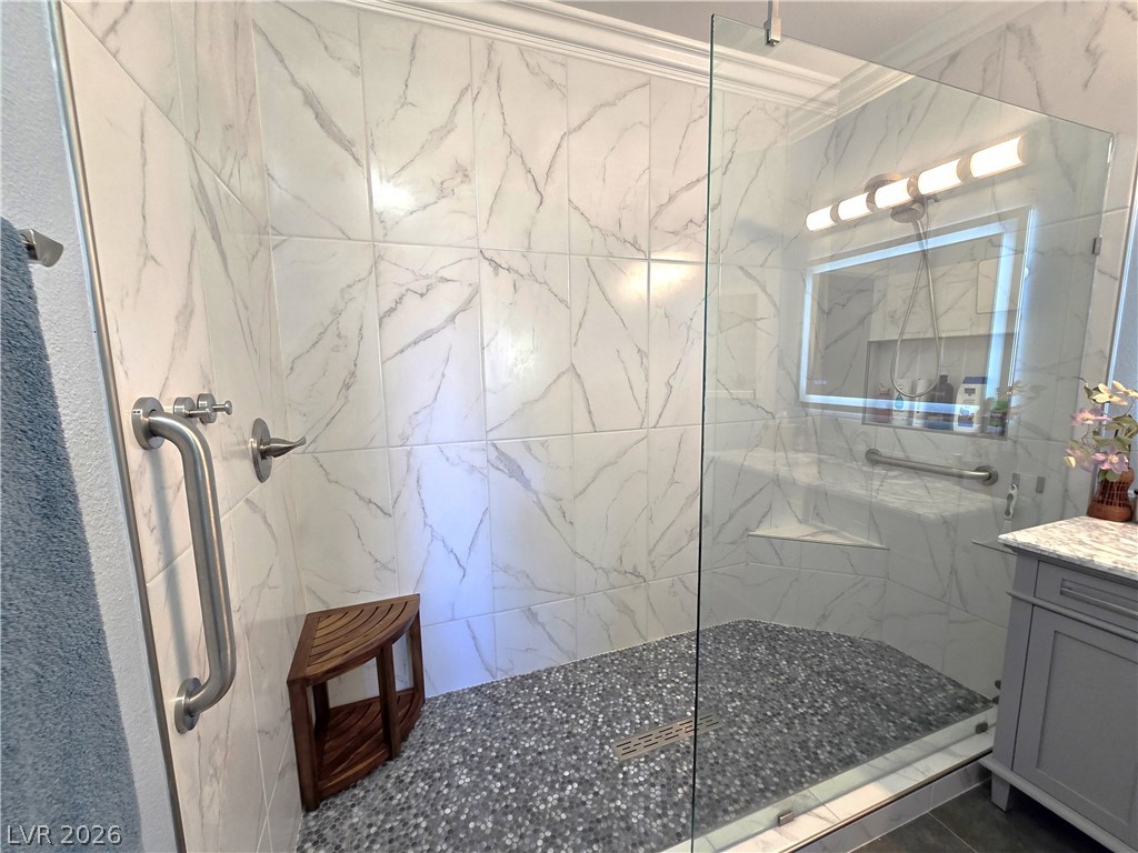 2050 West Warm Springs Road, Unit 2422 Henderson, NV 89014 - Photo 26 of 44 This sleek bathroom features a spacious walk-in shower with modern tile and functional grab bars.