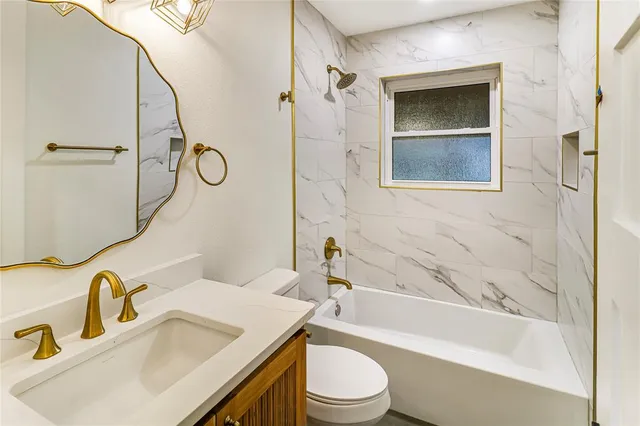 a bathroom with a sink a toilet and bathtub