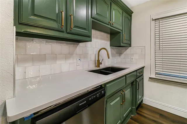 a kitchen with a sink and cabinets