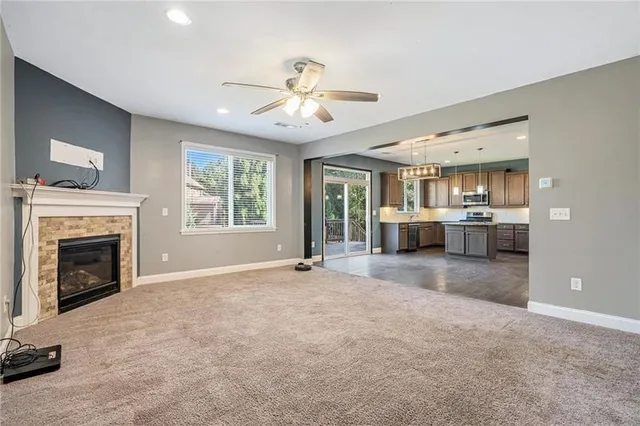 a view of an empty room with a fireplace and a window