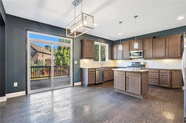 a kitchen with a sink window and cabinets