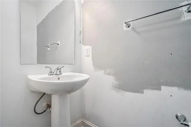a bathroom with a sink a toilet and a mirror