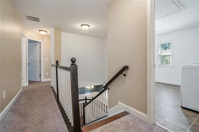 a view of a hallway with a room and stairs