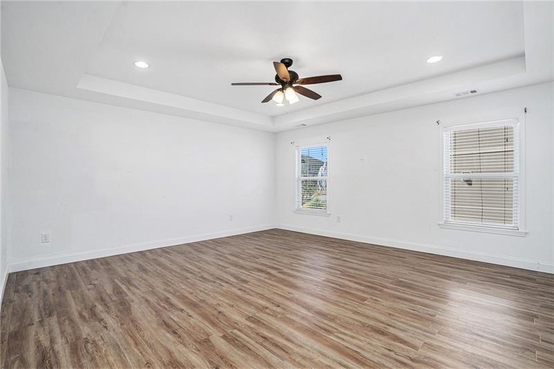 115 Floating Leaf Way Dallas, GA 30132 - Photo 19 of 49 an empty room with wooden floor ceiling fan and windows