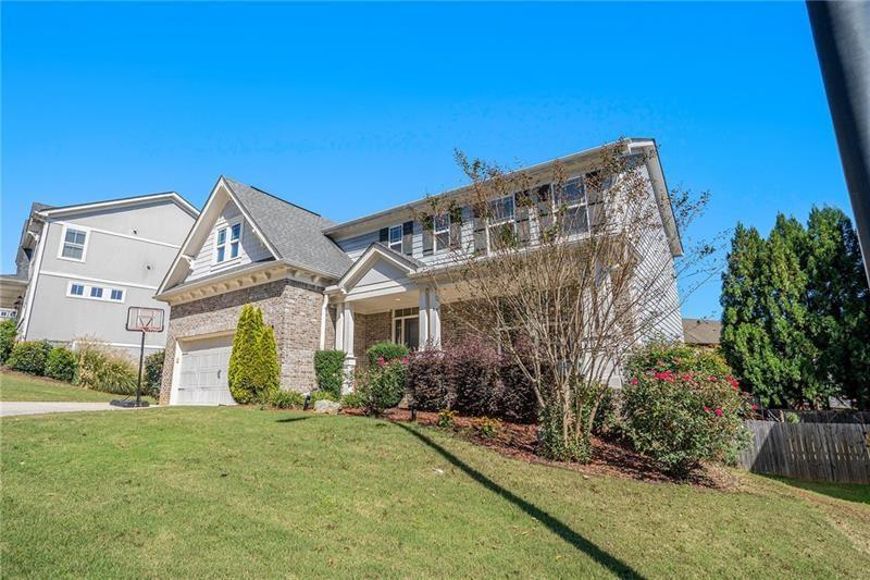 115 Floating Leaf Way Dallas, GA 30132 - Photo 2 of 49 a front view of a house with garden